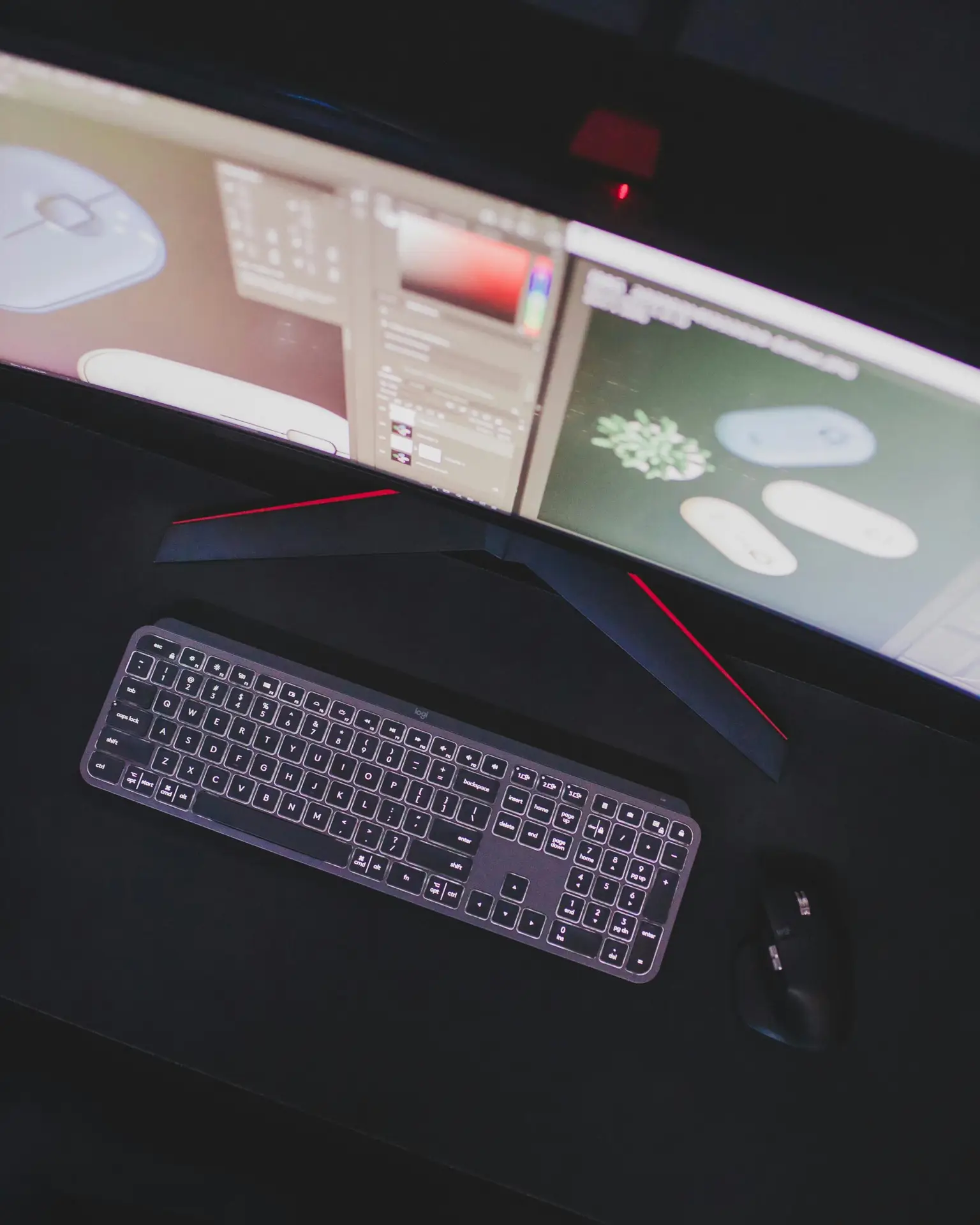 Modern computer setup featuring keyboard, mouse, and curved monitor displaying digital design software.